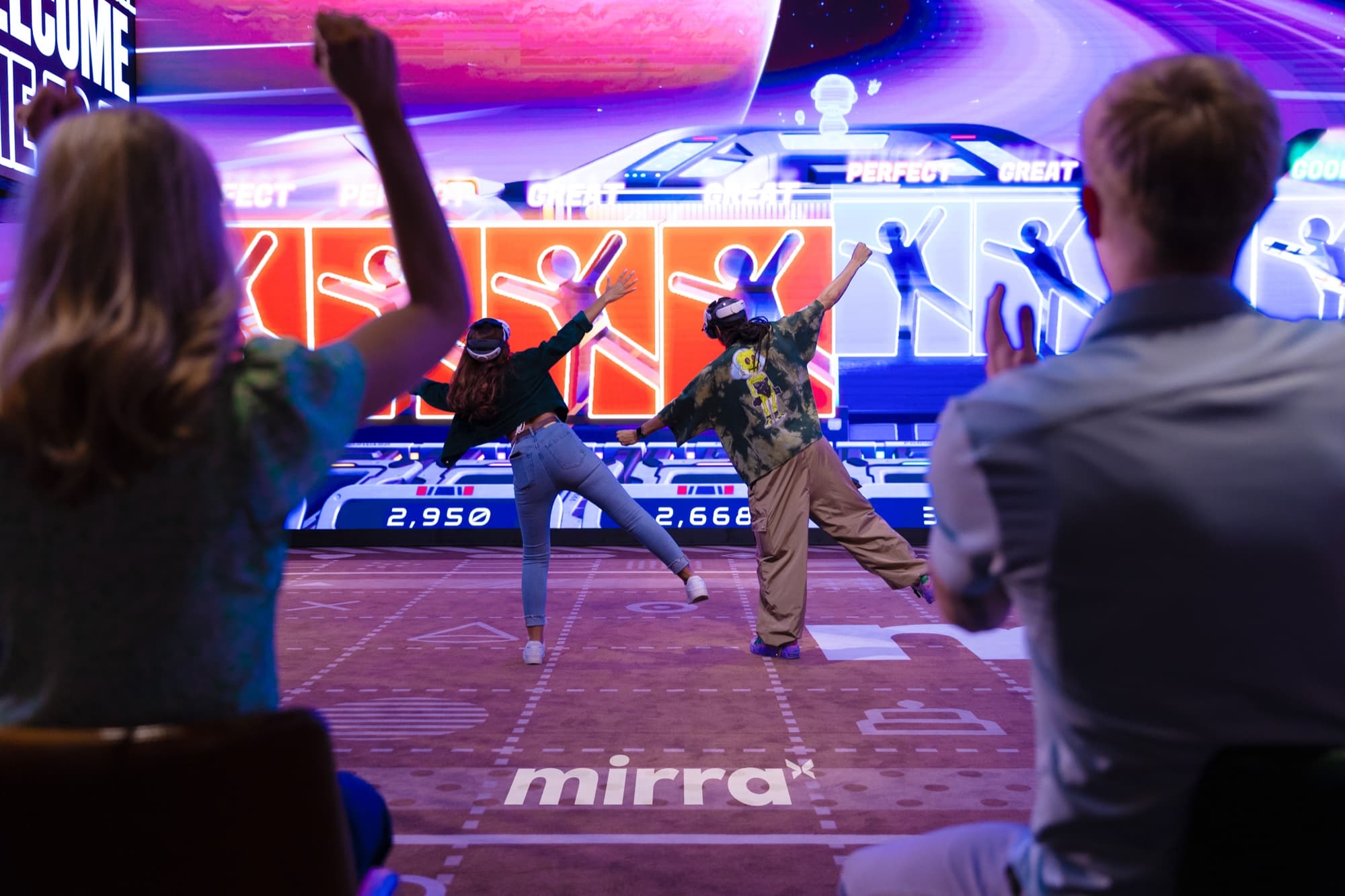 MirraArena players competing while friends watch the live display