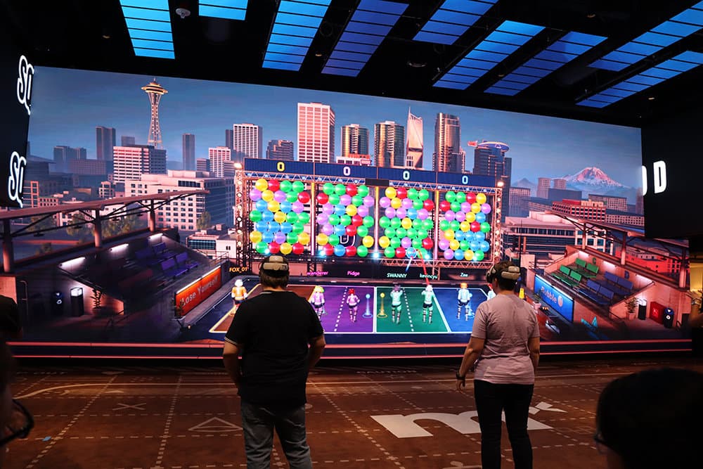 Arena with LED screen — players and spectators in frame